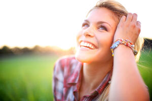 woman smiling in grassy field